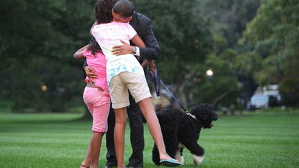 15 septembre 2009. Barack Obama est accueilli par un câlin de ses filles, au retour d'un déplacement dans l'Ohio et en Pennsylvanie.&nbsp; (DENNIS BRACK-POOL / GETTY IMAGES NORTH AMERICA)