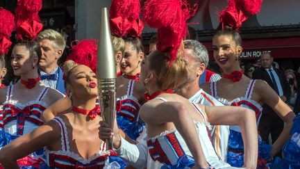 Et soudain, devant le Moulin Rouge, à Pigalle, un french cancan salue le passage de la flamme, le 15 juillet. (BRUNO LEVESQUE / MAXPPP)