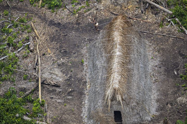 Un homme court avec une machette à la main. Les membres de la tribu ont progressivement acquis des objets en métal lors de raids dans d'autres tribus non "isolées".&nbsp; (RICARDO STUCKERT)