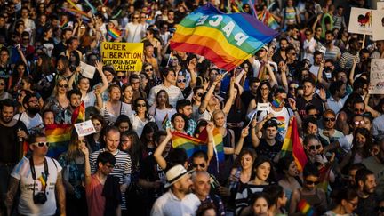 People march with a rainbow flag, a symbol of the LGBT+ community, in Sofia, Bulgaria, on June 9, 2021. (DIMITAR DILKOFF / AFP)