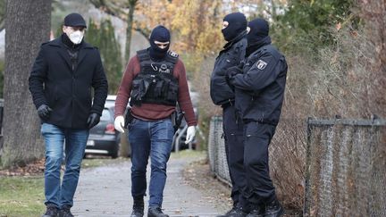 Des policiers allemands à Berlin, le 7 décembre 2022, lors d'un coup de filet visant un réseau  d'extrême droite. (ABDULHAMID HOSBAS / ANADOLU AGENCY / AFP)