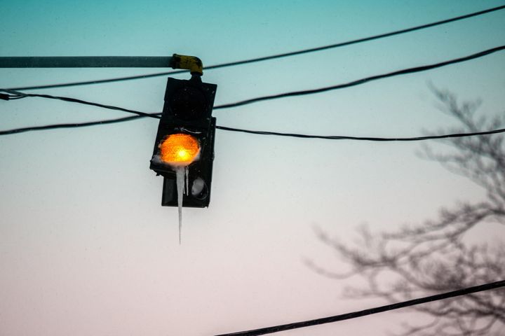 Ice has formed around a traffic light, in Stony Brook, New York, on January 29, 2022.   (ANDREW THEODORAKIS / GETTY IMAGES NORTH AMERICA / AFP)