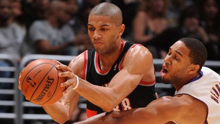 Nicolas Batum ballon en mains face à Henry