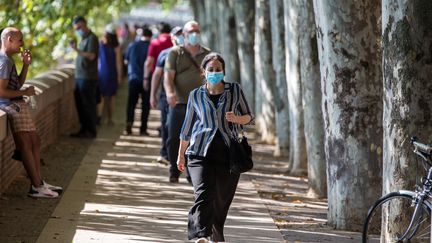 Des passants portent le masque dans les rues de Toulouse (Haute-Garonne), le 14 août 2020. (FREDERIC SCHEIBER / HANS LUCAS / AFP)