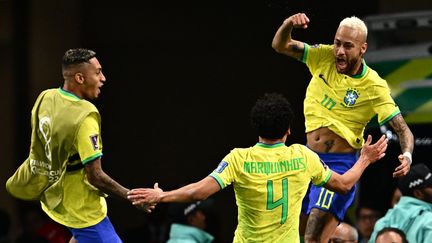 Raphinha, Marquinhos et Neymar célèbrent l'ouverture du score brésilienne face à la Croatie, le 9 décembre 2022 à Al Rayyan. (GABRIEL BOUYS / AFP)