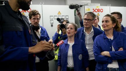 La candidate du Nouveau Front populaire pour Matignon, Lucie Castets, est en visite dans les locaux de Duralex, à La Chapelle-Saint-Mesmin (Loiret), avec les chefs de partis socialiste et écologiste Olivier Faure et Marine Tondelier, le 31 juillet 2024. (GUILLAUME SOUVANT / AFP)