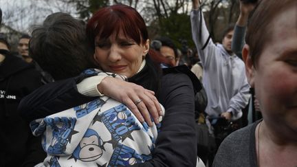 Un enfant ukrainien retrouve sa famille à Kiev (Ukraine), le 22 mars 2023. (SERGEI CHUZAVKOV / AFP)