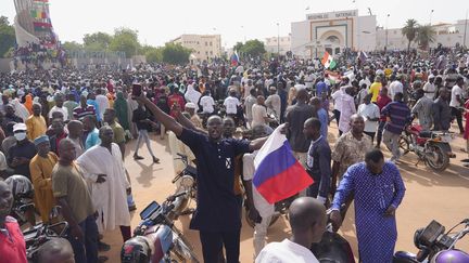 A protester waves a Russian flag during a march in support of General Abdourahmane Tchiani after his successful coup d'état in Niger, in Niamey, on July 30, 2024. (SAM MEDNICK / AP / SIPA)