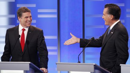 Le candidat &agrave; l'investiture r&eacute;publicaine Mitt Romney (&agrave; droite) s'adresse &agrave; son rival Rick Perry (&agrave; gauche) lors du d&eacute;bat de Des Moines dans l'Iowa (Etats-Unis), le 10 d&eacute;cembre 2011. (JEFF HAYNES / REUTERS)