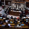 Le ministre du Travail, Olivier Dussopt, s'exprime au micro devant les députés, le 7 mars 2023 à l'Assemblée nationale. (THOMAS SAMSON / AFP)