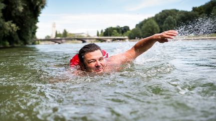 Benjamin David se rend au travail à la nage dans l'Isar, le 28 juin 2017 à Munich (Allemagne). (ALEXANDER HEINL / DPA / AFP)