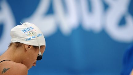 &lt;p&gt;Les Jeux olympiques de P&amp;eacute;kin sont un &amp;eacute;chec. Elle se qualifie pour les finales olympiques, mais termine loin des meilleures. En larmes, elle annonce qu'elle songe &amp;agrave; arr&amp;ecirc;ter. Six mois plus tard, elle d&amp;eacute;clare :&amp;nbsp;"C'est d&amp;eacute;cid&amp;eacute;, j'arr&amp;ecirc;te, ce n'est pas un coup de t&amp;ecirc;te". Elle n'a que 22 ans.&lt;/p&gt; (MARTIN BUREAU / AFP)