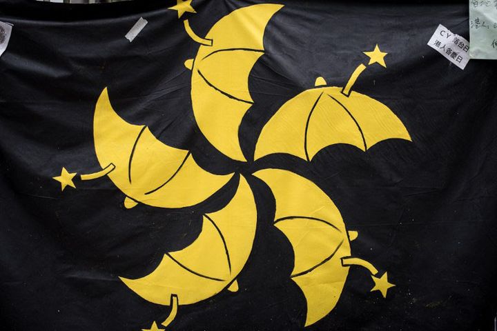 Un drapeau où les pétales de fleur, emblème de Hong Kong, ont été remplacés par des parapluies, symbole de la protestation des étudiants
 (PHILIPPE LOPEZ / AFP)