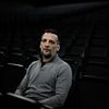 L'acteur et réalisateur Mathieu Kassovitz, le 15 février 2024, assis dans la salle de la LDLC Arena, à Décines-Charpieu (Rhône), près de Lyon. (JEFF PACHOUD / AFP)