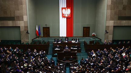 Polish Prime Minister Donald Tusk in front of the Sejm, the lower house of parliament, on December 12, 2024 in Warsaw, Poland. (JAKUB PORZYCKI / NURPHOTO / AFP)