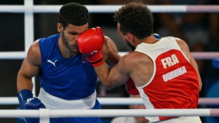 Frenchman Sofiane Oumiha faces Cuban Erislandy Alvarez in the -63.5kg final at the Paris 2024 Olympic Games on August 7, 2024. (MOHD RASFAN / AFP)