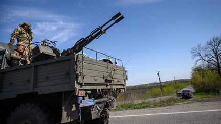 Des militaires ukrainiens sur un véhicule blindé de transport de troupes sur une autoroute dans la banlieue de Kryvyi Rih, le 28 avril 2022. (ED JONES / AFP)