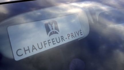 Affiche "Chauffeur privé" derrière un pare-brise d'un VTC à Paris le 11 février 2016. (AFP)