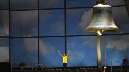 Doooong ! Le r&eacute;cent vainqueur du Tour de France, le Britannique Bradley Wiggins, a sonn&eacute; la cloche pour lancer la c&eacute;r&eacute;monie d'ouverture, sous les vivats du public. (ADRIAN DENNIS / AFP)