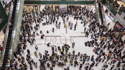 Des militants pro-démocratie rassemblés dans un centre commercial du district de Sha Tin, le 12 octobre 2019.&nbsp; (DALE DE LA REY / AFP)