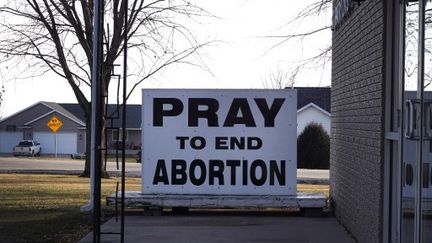 An anti-abortion sign is placed in front of St. Patrick's Catholic Church in Winthrop, Iowa, on December 20, 2023. (SCOTT OLSON / GETTY IMAGES NORTH AMERICA / AFP)