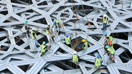 Des ouvriers achèvent dimanche 27 septembre 2015 le dôme monumental du Louvre Abu Dhabi.
 (WAM / AFP)