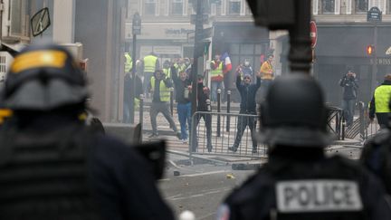 Des manifestants font face à la police, le 1er décembre 2018 à Paris lors d'une manifestation des "gilets jaunes". (MICHEL STOUPAK / NURPHOTO / AFP)