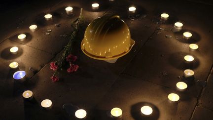 &nbsp; (Un casque et une fleur en hommage aux victimes de l'explosion © Reuters)