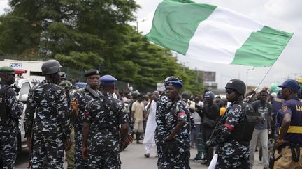 Police officers guard a protest against the high cost of living in Lagos, Nigeria, Friday, Aug. 2, 2024. (SUNDAY ALAMBA/ AP/SIPA)