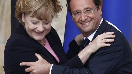 Angela Merkel et François Hollande le dimanche 8 juillet à Reims. (JACKY NAEGELEN / POOL / AFP)