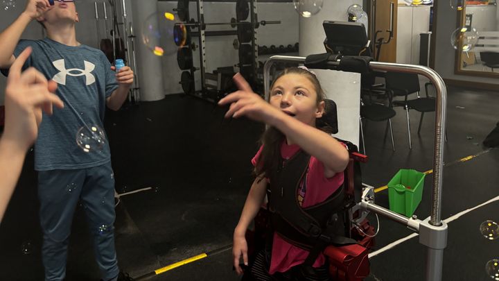 Lucy, who suffers from a rare genetic disease, is testing an exoskeleton for children in Dublin. (CLEMENCE PENARD / RADIOFRANCE)