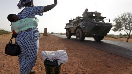 Une femme salue des soldats fran&ccedil;ais apr&egrave;s la lib&eacute;ration de Diabaly, le 24 janvier 2013. (ERIC GAILLARD  / REUTERS)