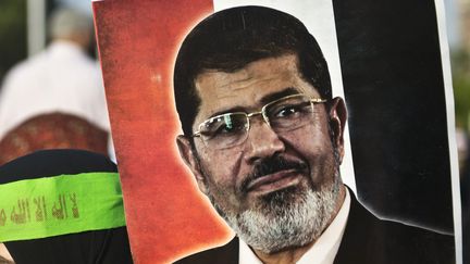 Une partisane de Mohamed Morsi brandit son portrait, le 3 juillet 2013 au Caire (Egypte). (KHALED DESOUKI / AFP)